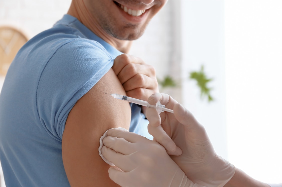 Ein Mann bekommt eine Impfung in den Arm