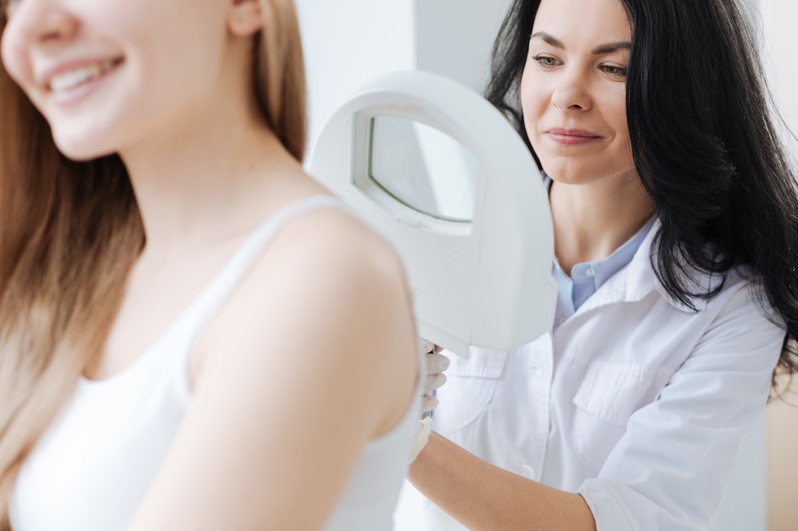 Je früher Hautkrebs erkannt wird, desto besser. Eine Ärztin untersucht den Rücken einer weiblichen Patientin