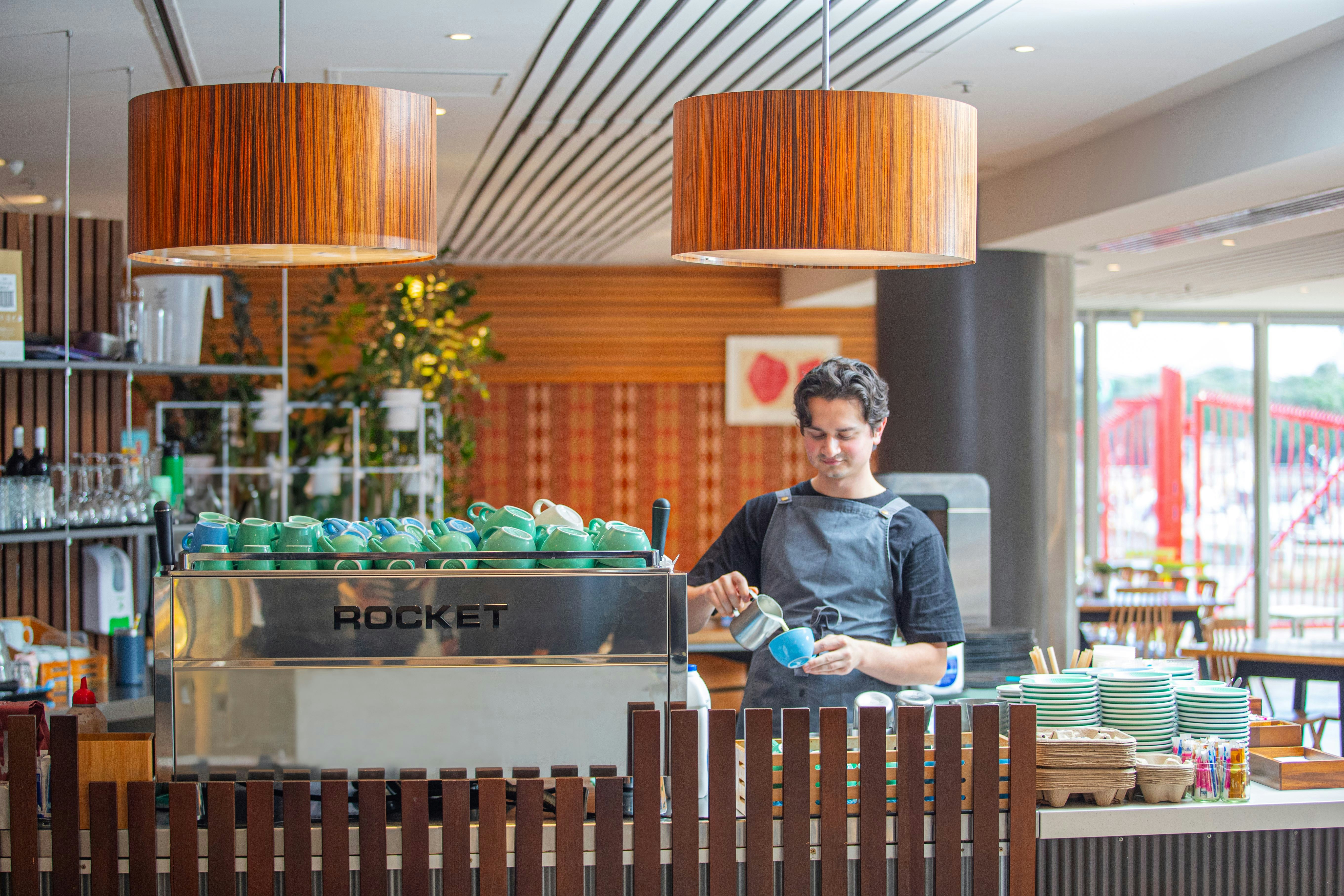 A barista makes a cappuccino at Te Papa Cafe.
