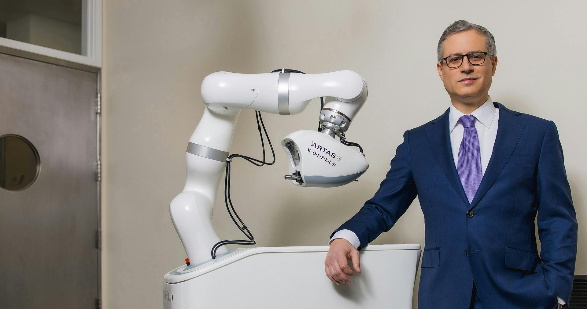 Dr. Wolfeld leaning on artas machine