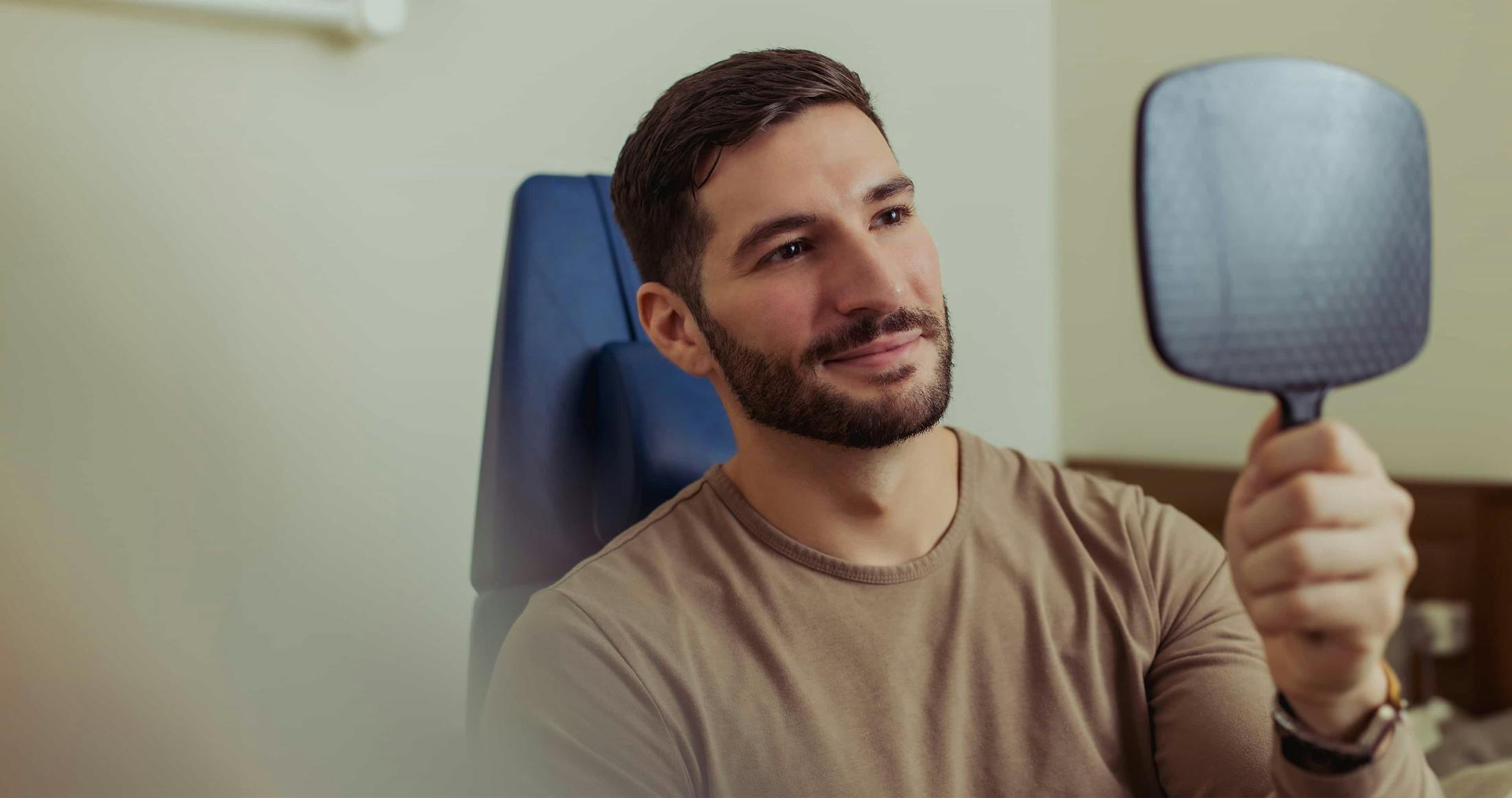 Man looking into mirror smillng