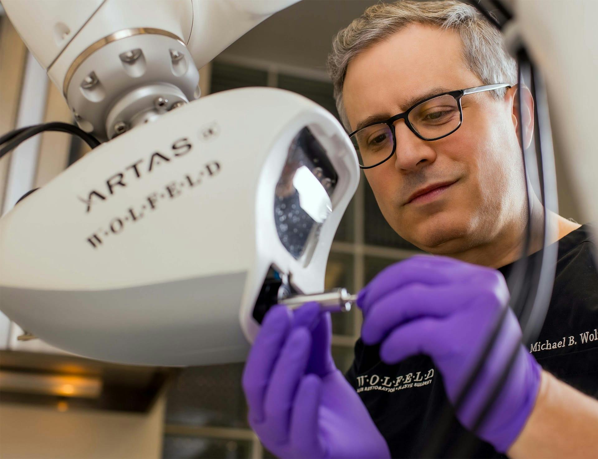 Dr. Wolfeld working with artas machine