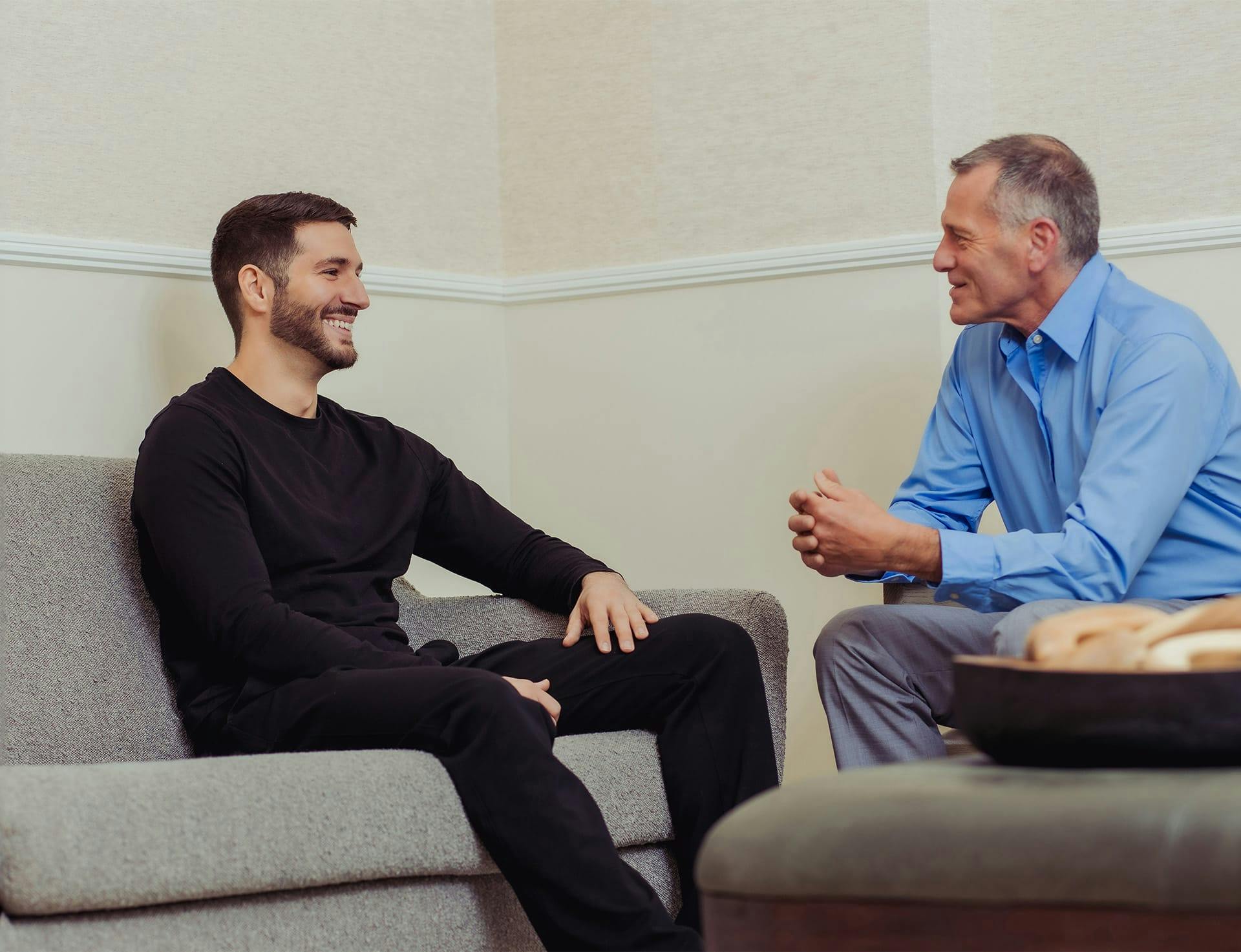 two men chatting in waiting room