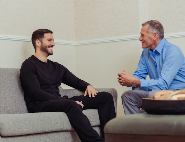two men chatting in waiting room