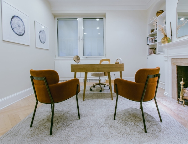 a desk and three chairs