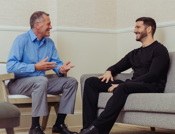 two men chatting in waiting room