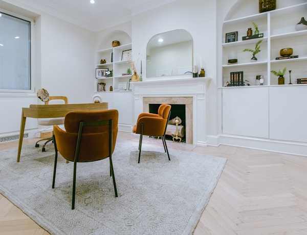a desk and three chairs
