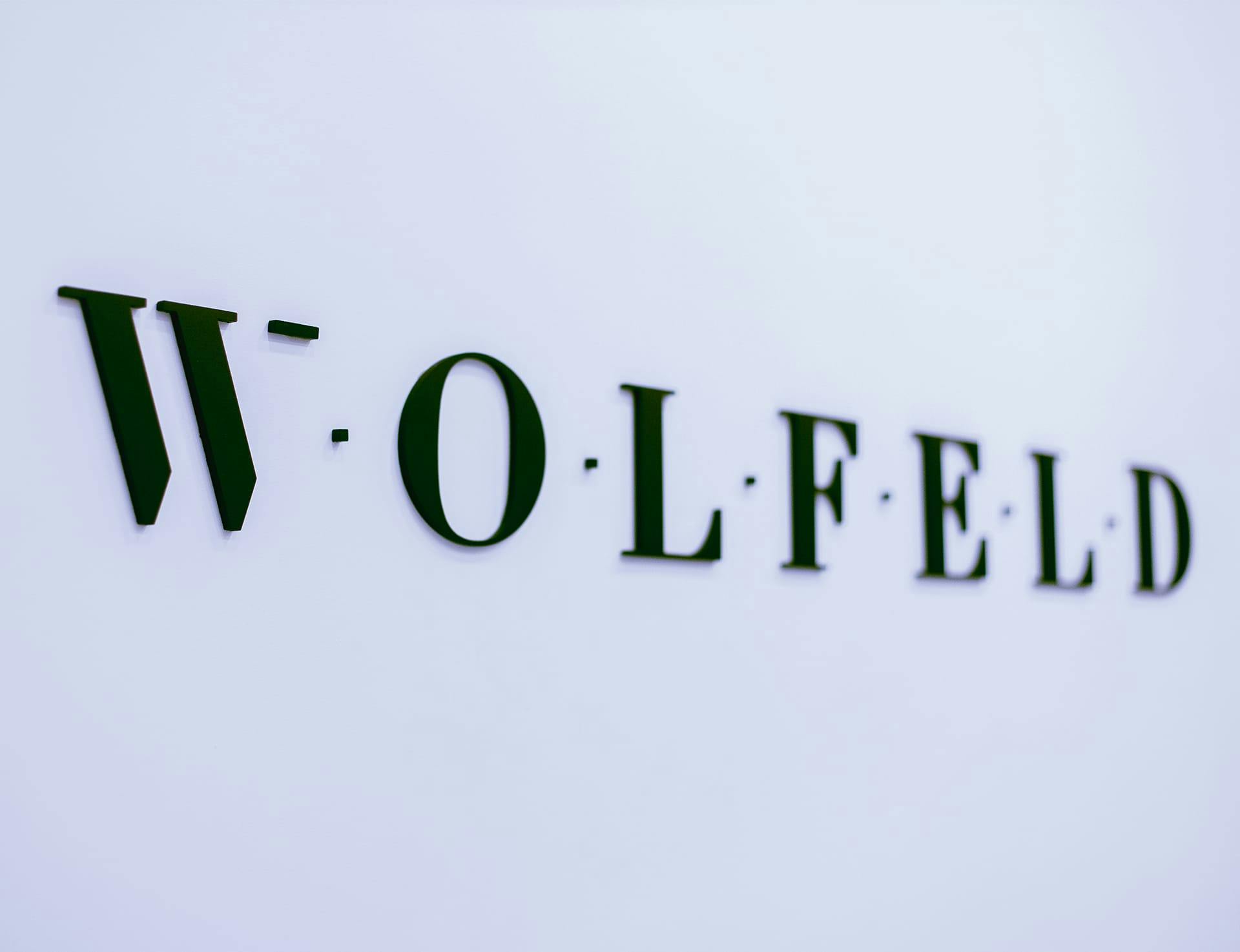 Wolfeld logo on wall