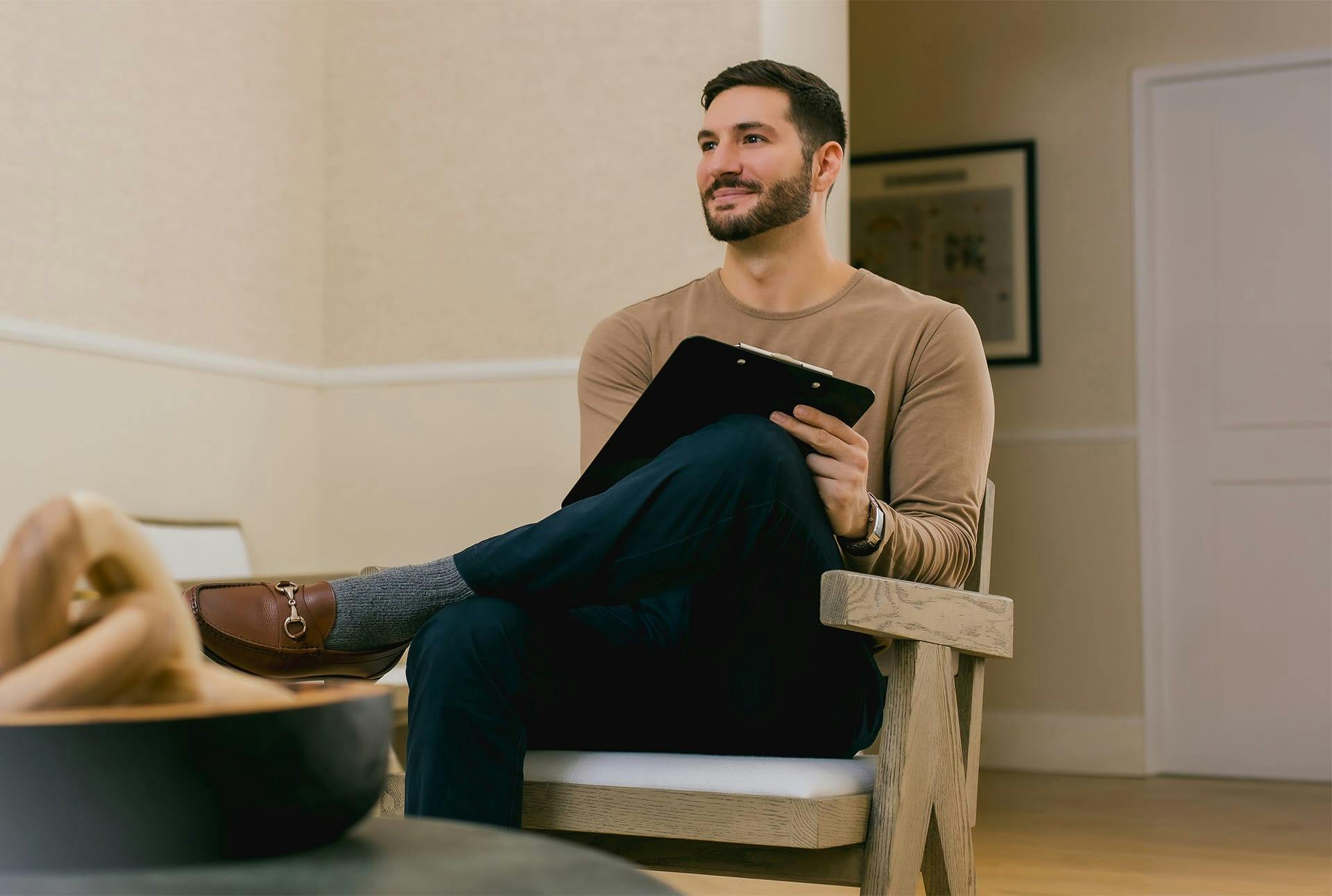 man sitting in waiting room smiling
