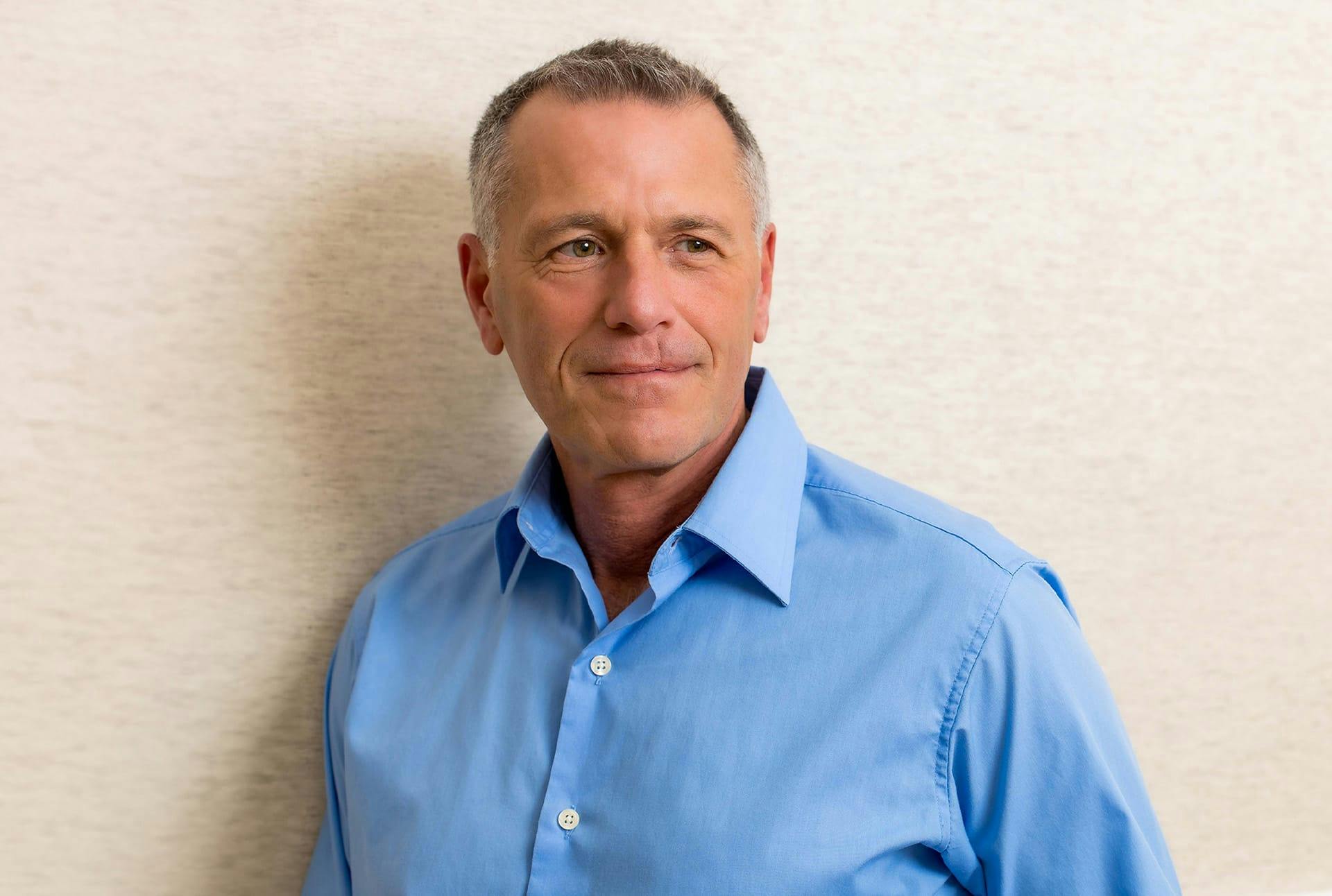 man in a blue button up shirt