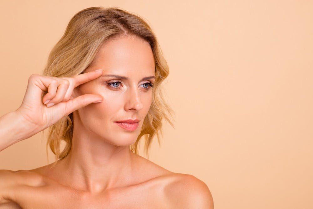 Botox being administered near the eyes of a patient