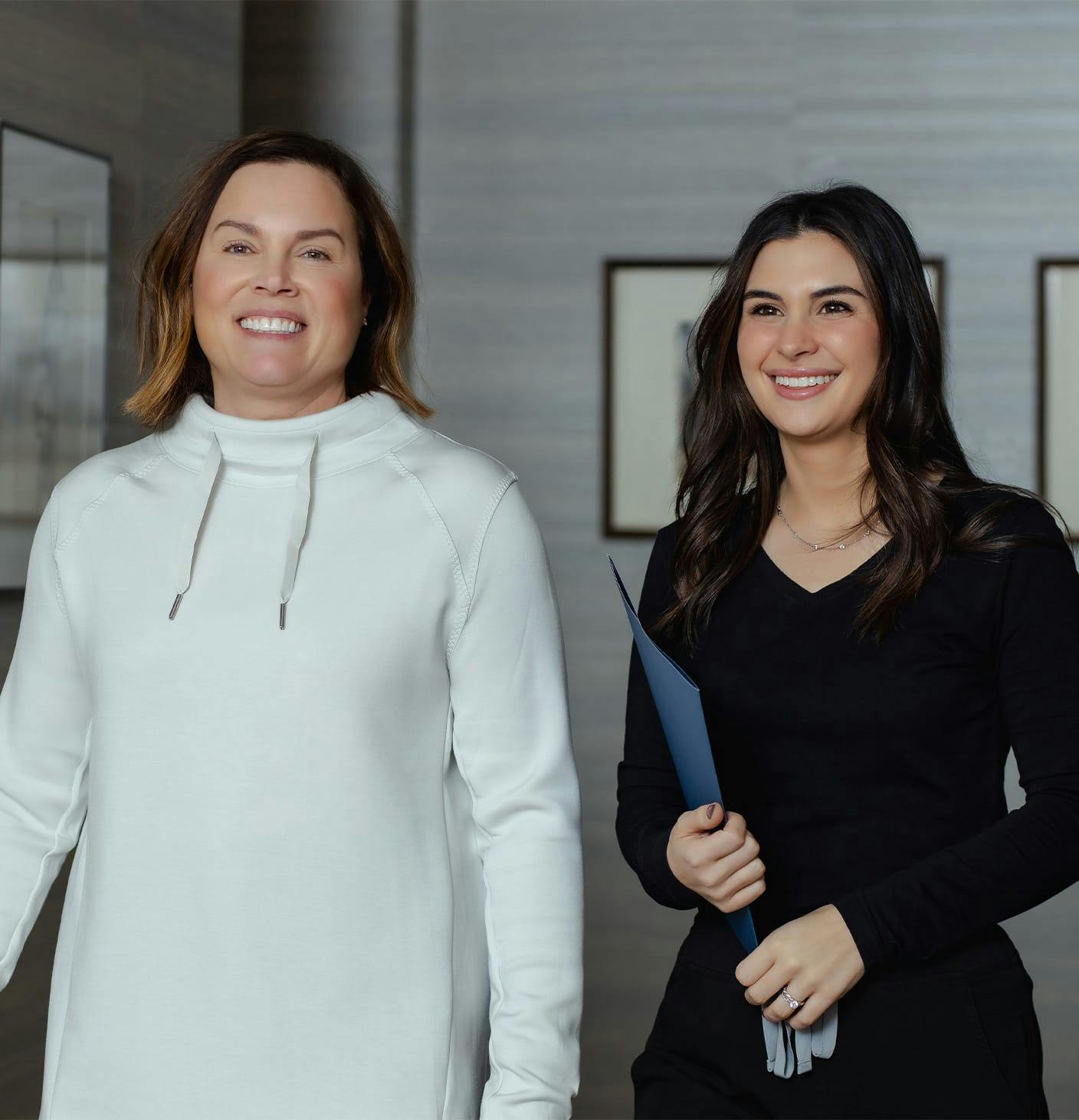two smiling women walking
