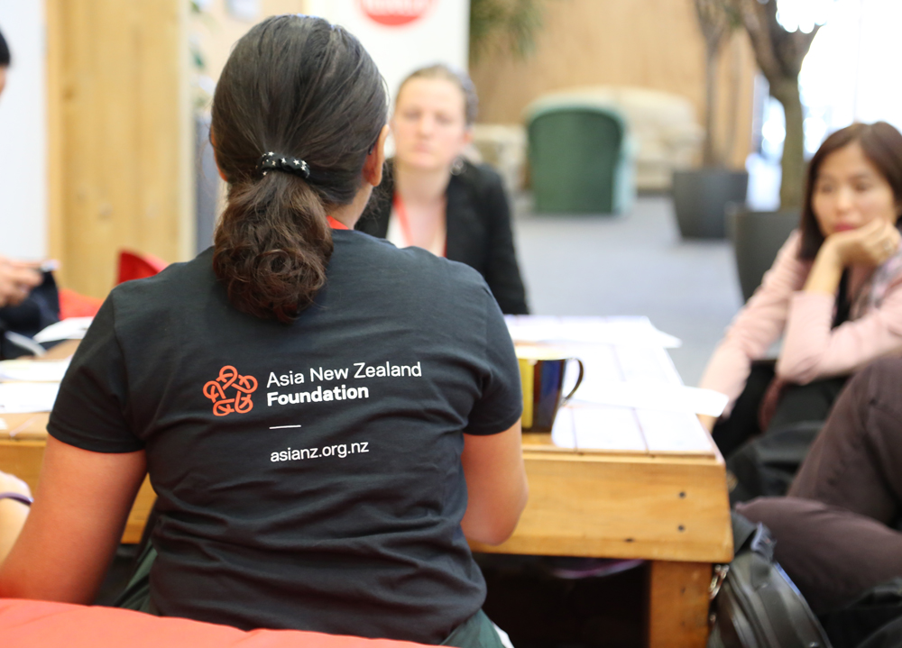 Woman with ANZF top on with back to camera