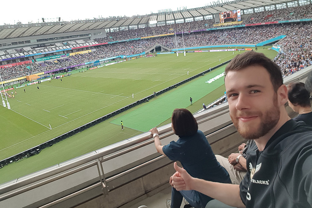 Gareth sitting in the stands at a Rugby World Cup match