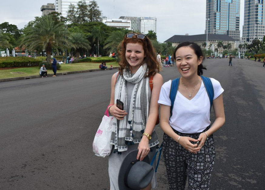 Jessie walking down street with fellow intern