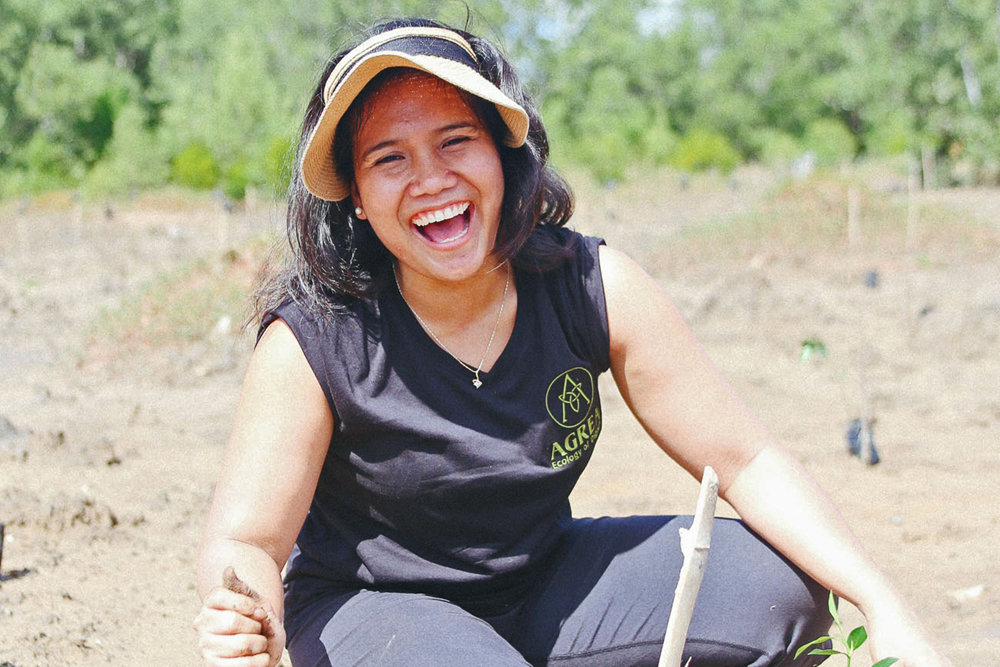 Cherrie Atilano crouching in a field