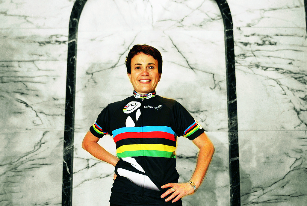 Paula standing in a foyer wearing a cycling top