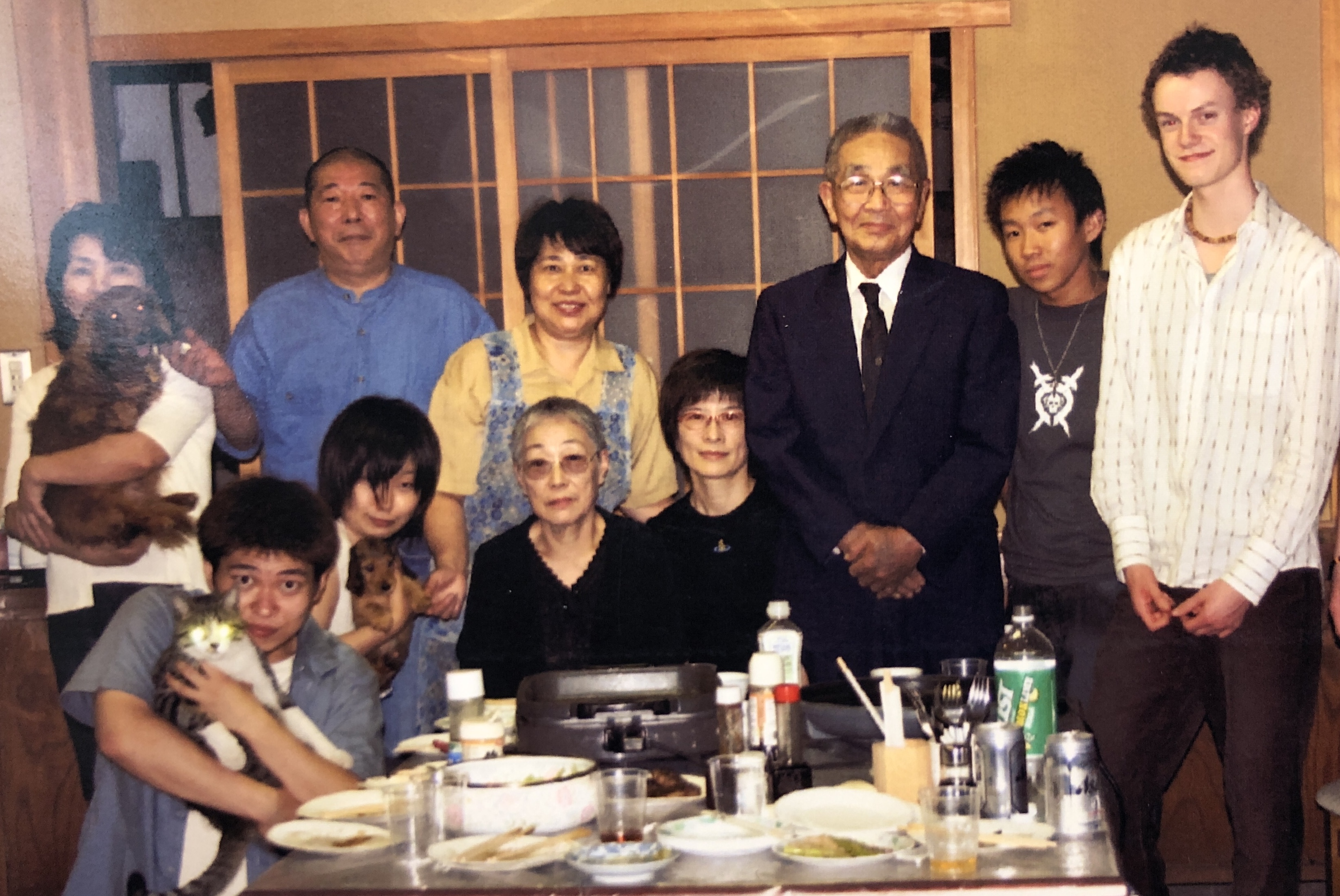 Marcus standing around a set table with his Japanese homestay family