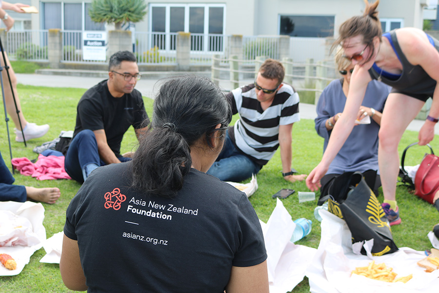 Leadership Network members sitting on grass eating fish and chips