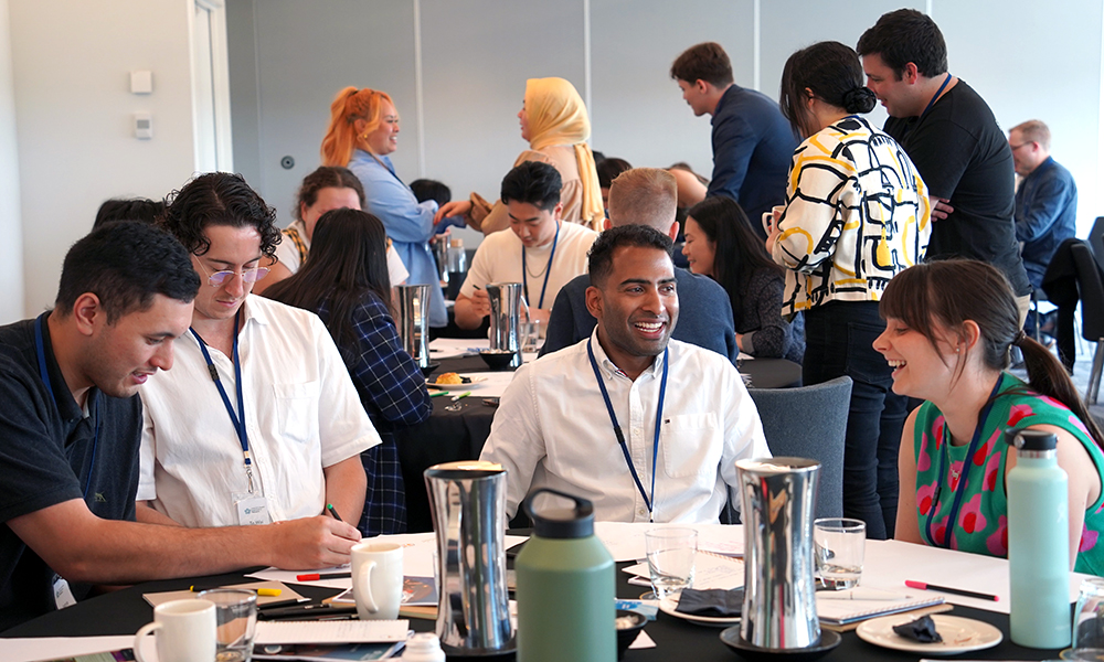 Groups of Leadership Network members sitting at tables chatting