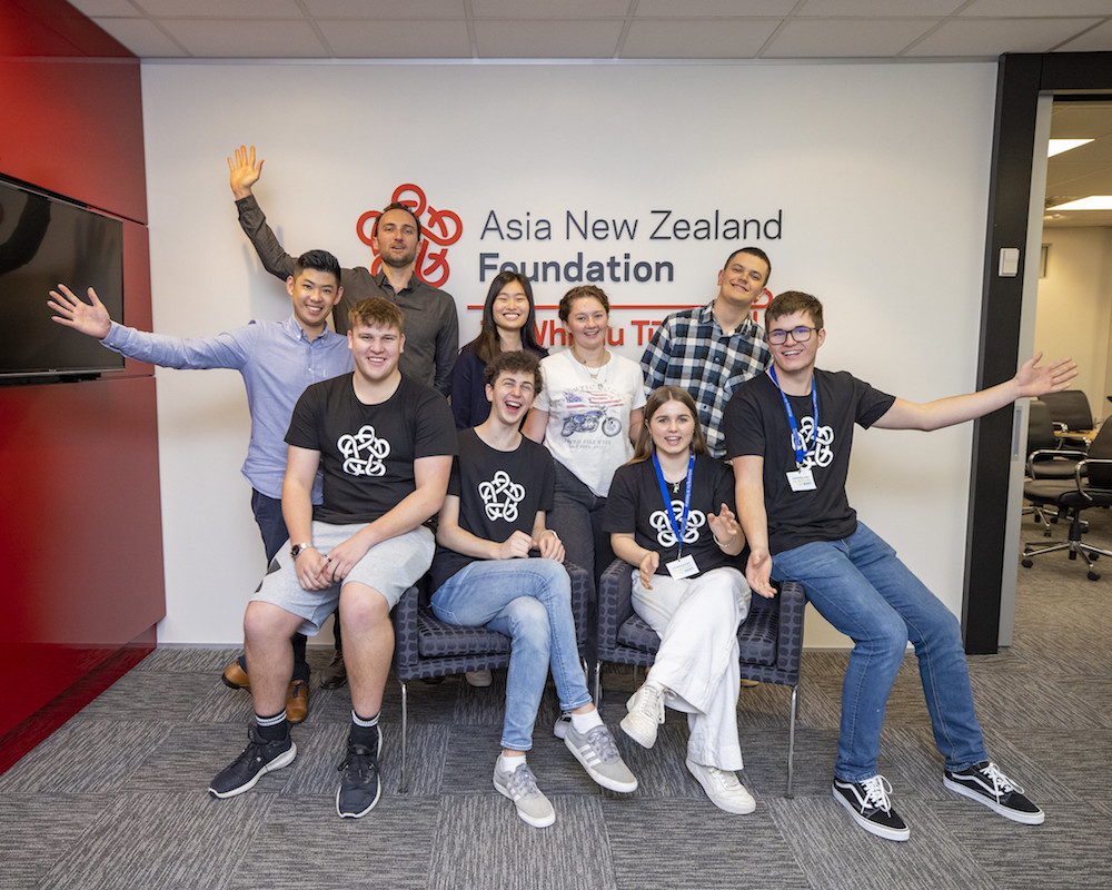 The Foundation team posing in front of Foundation signage