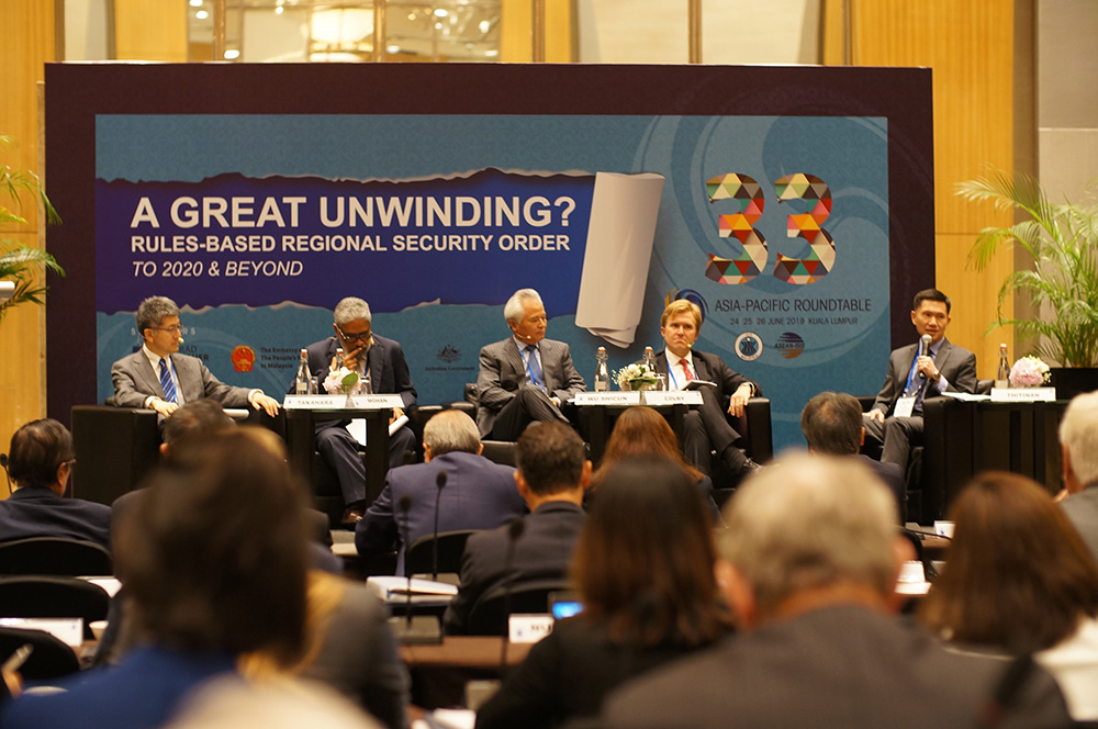 A panel addressing a conference room
