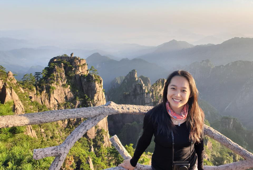 Alice Wang with Huangshan mountains behind her