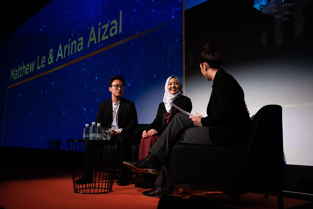 Arina on a stage being interviewed