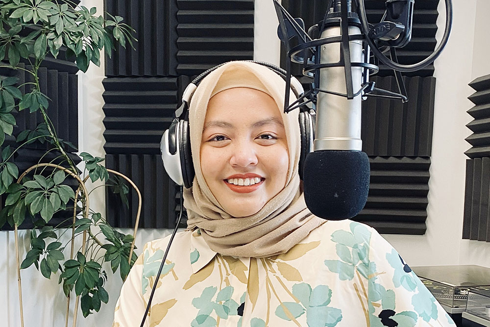 Arina with a studio microphone in front of her