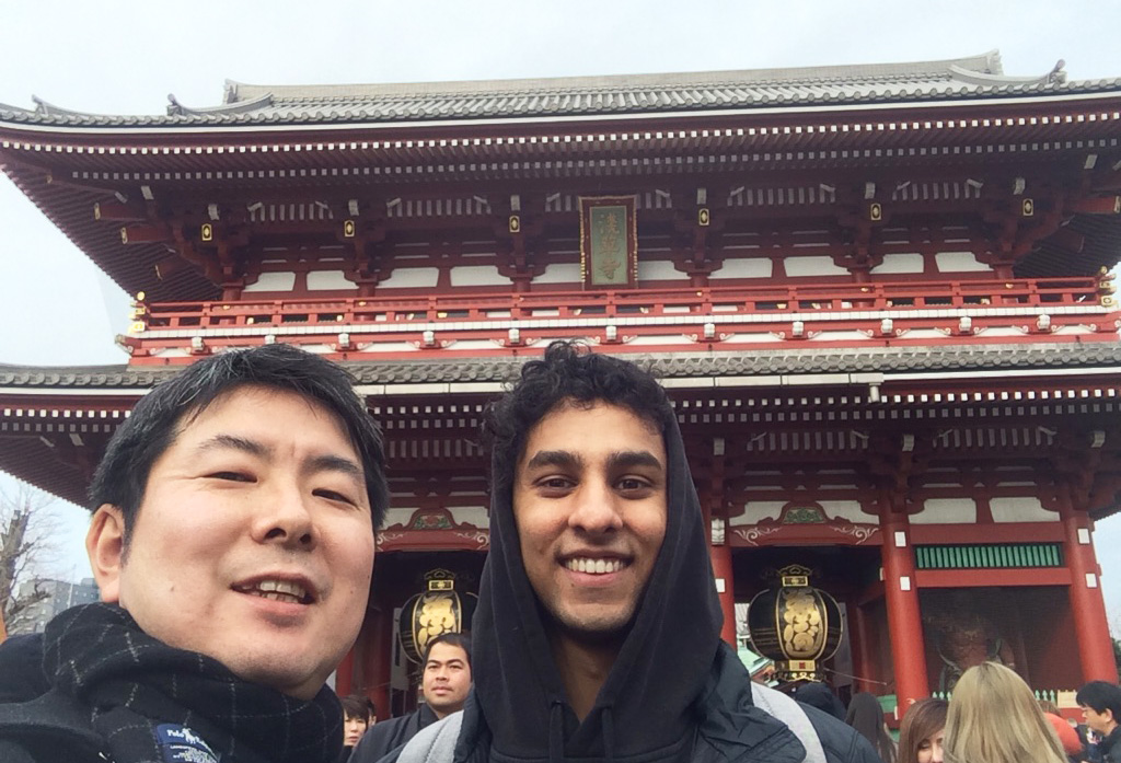 Arjun and a friend in front of a temple
