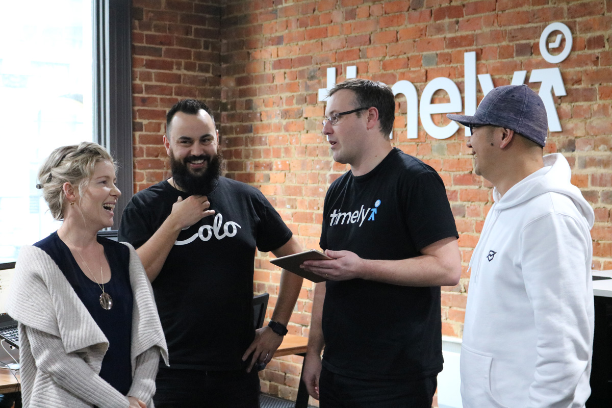 Four tech entrepreneurs from Timely standing in a row
