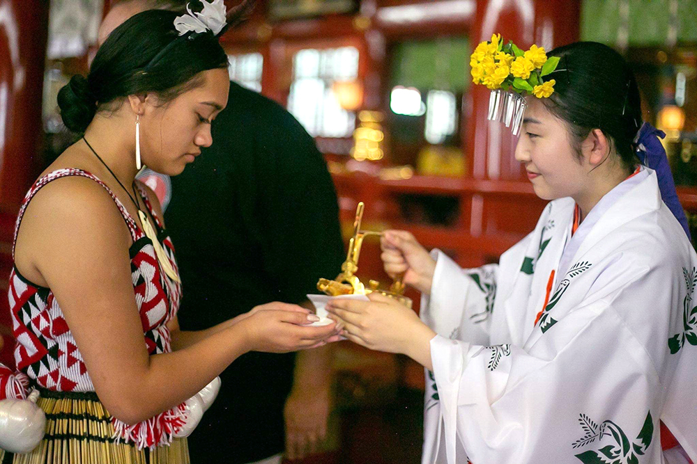 Atera accepting a cup of tea during a Japanese tea ceremony