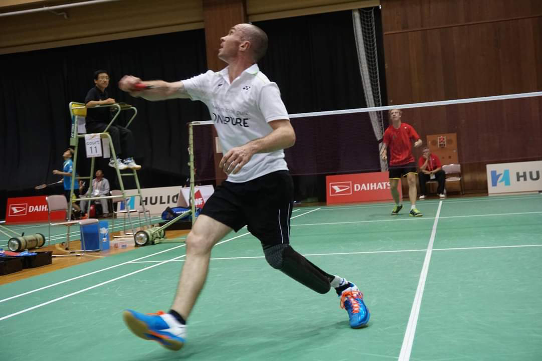 Corrie hitting a shuttlecock during a game