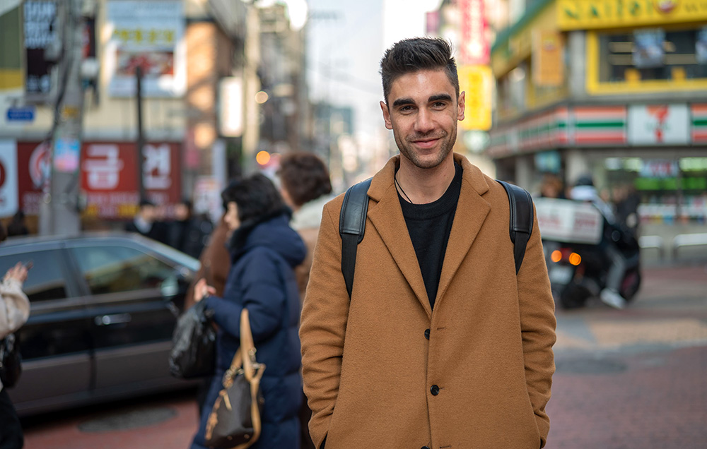 Benjamin Brooking standing on a street in Seoul