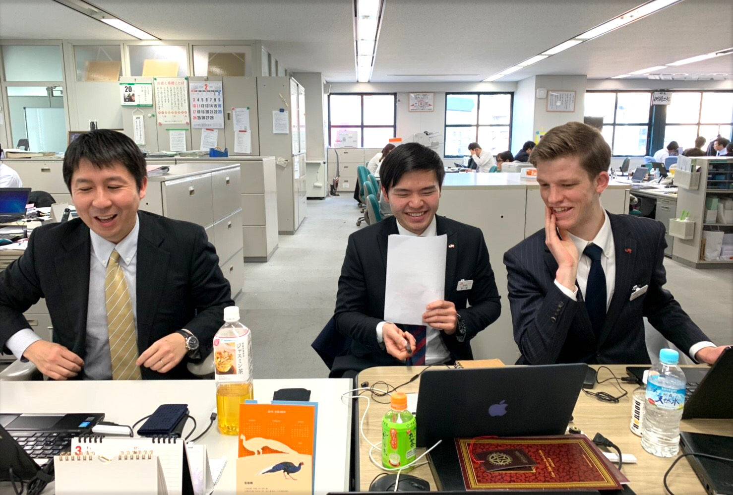 Benjamin sitting at a desk with colleagues