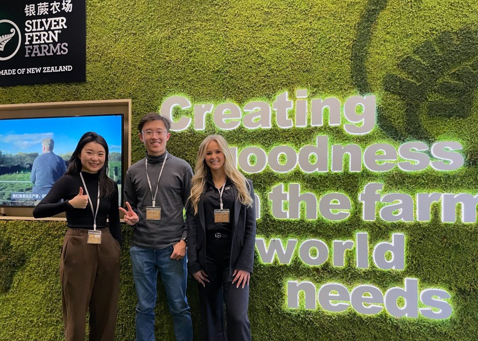 Brendan standing in front of a Silver Fern Farms sign with a colleague on either side of him