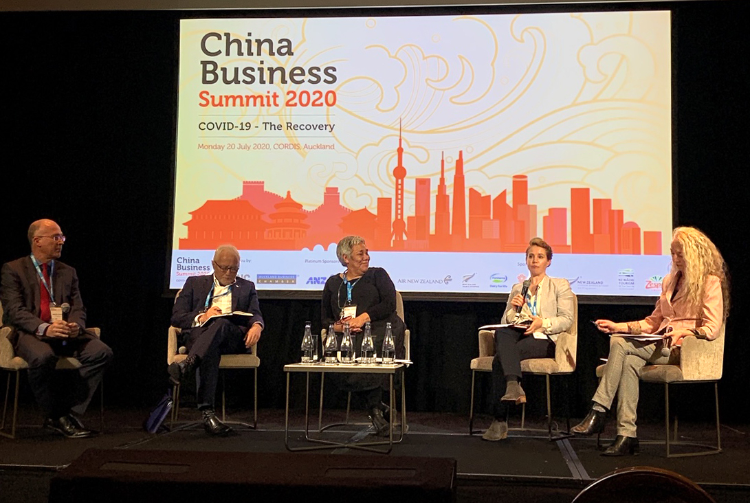 Felicity Roxburgh addressing an audience alongside fellow panelists