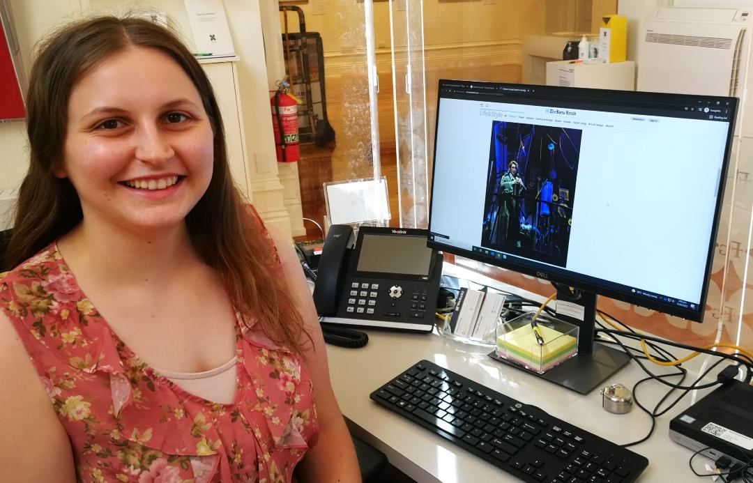 Philippa sitting at a desk in front of a computer screen