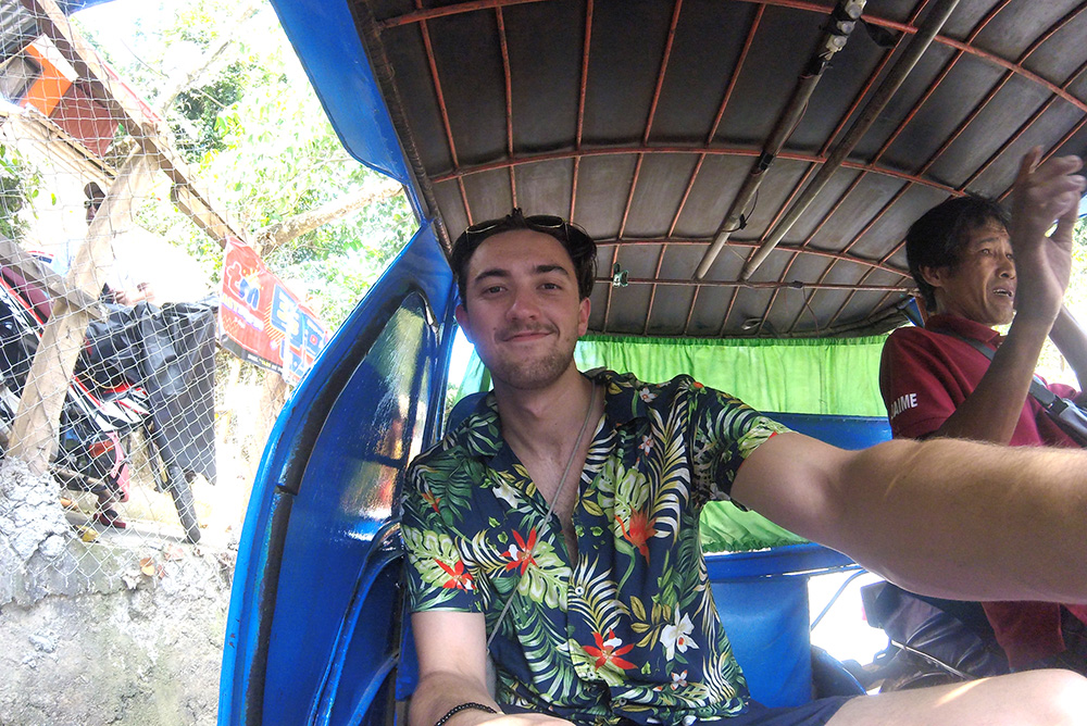 Calum sitting in a tuk tuk
