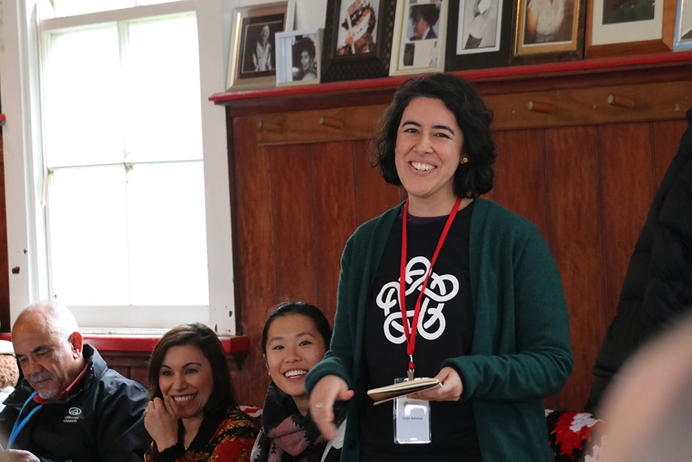 Claire speaking at a meeting house at Te Tii Marae