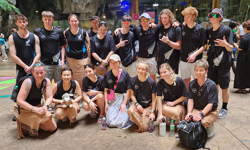 The team posing for a group photo in their black team shirts