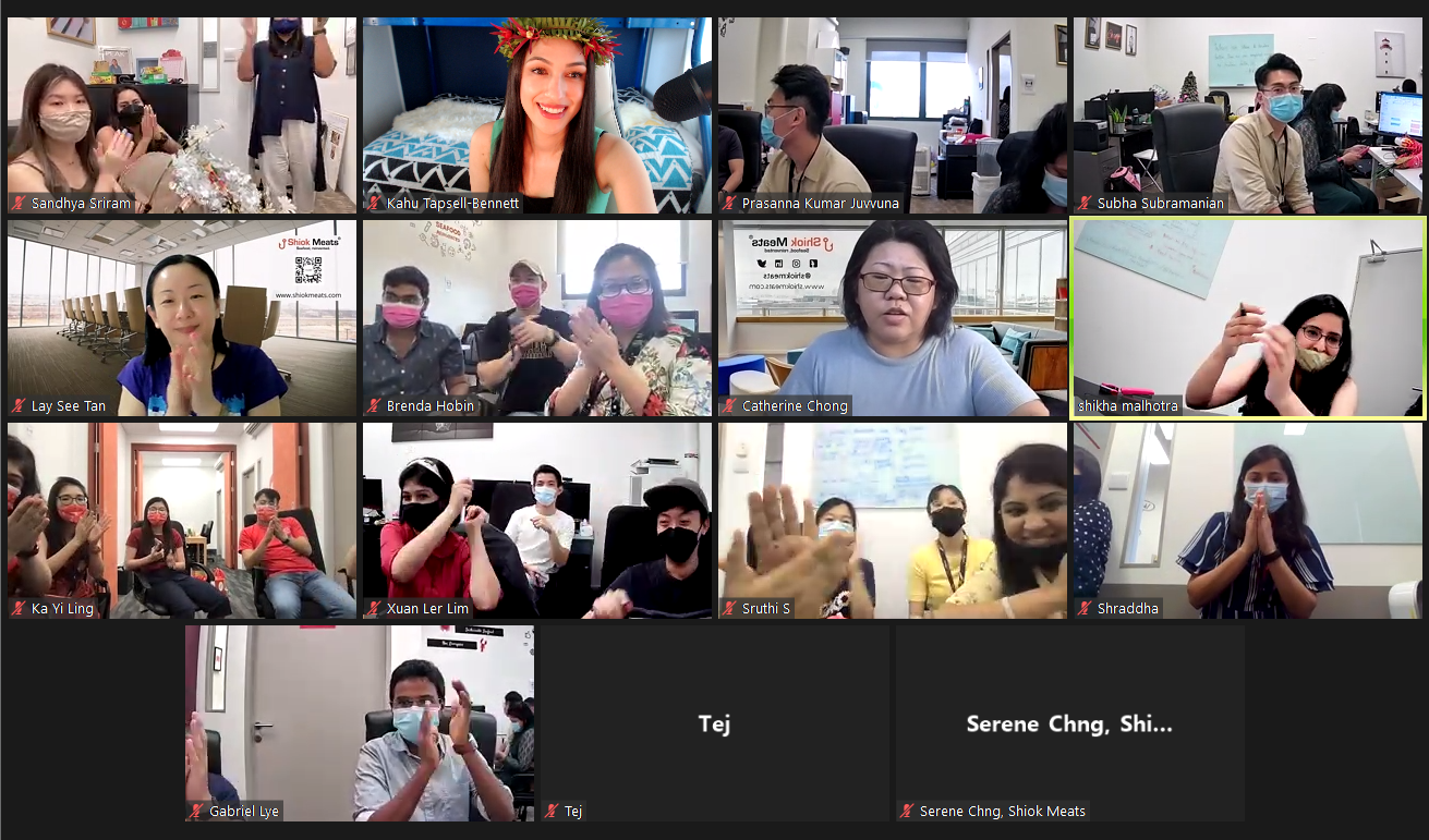 A screenshot of a Zoom call with people clapping