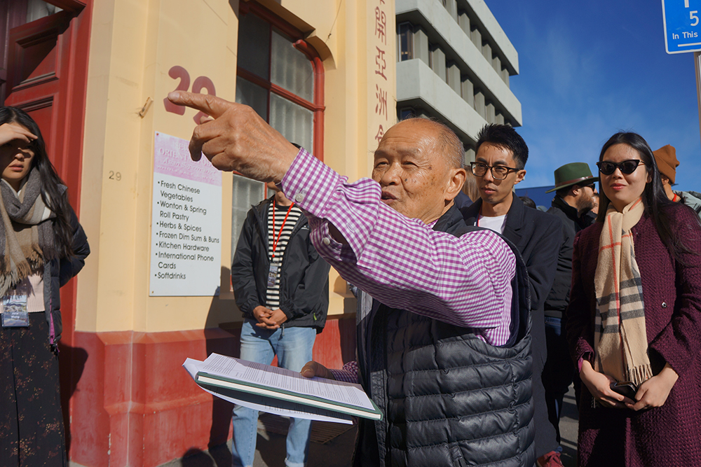 Duncan Sew Hoy pointing out something to the group in Dunedin