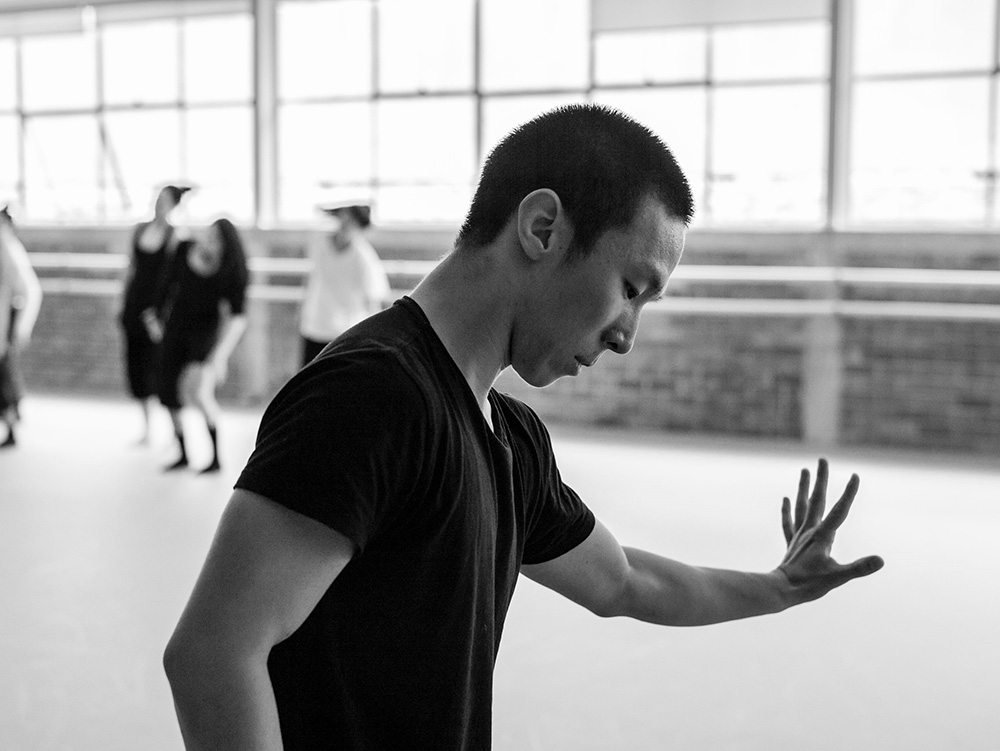 A performer leaning against a mirror