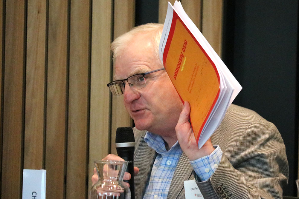 A man holding up a copy of the Seriously Asia 2003 research report