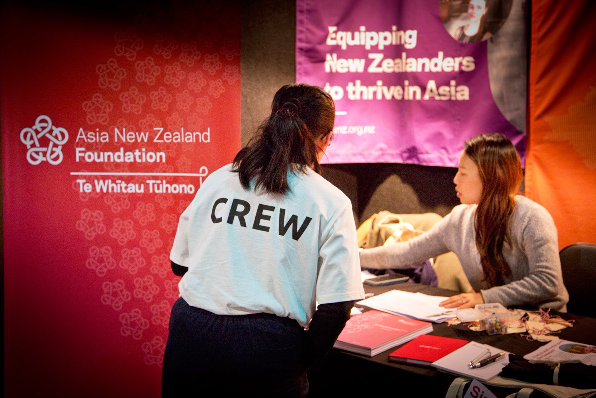 A Festival for the Future crew member talking to A Foundation staff member at the Foundation stall