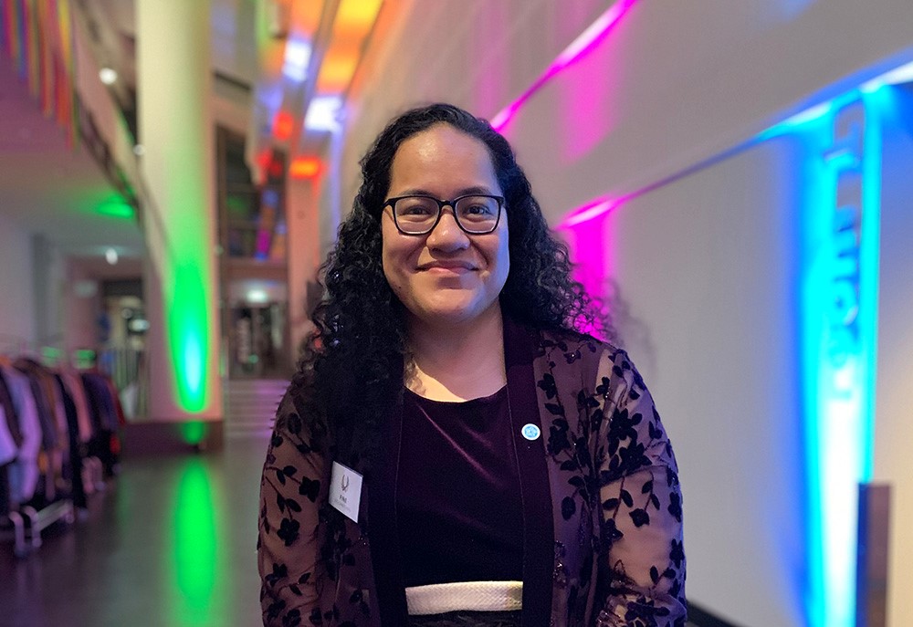 Fine standing in a hallway lit by multi-coloured lights