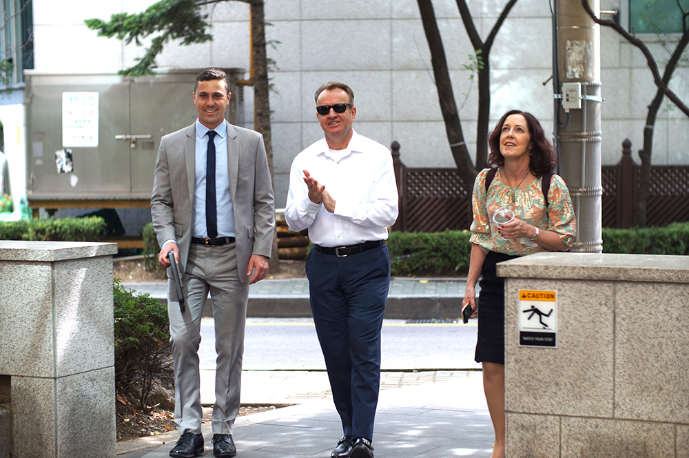 Fraser Bermingham  walking outside with Simon Draper and Tracy Epps