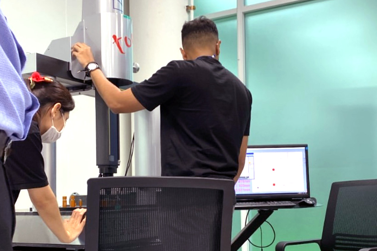A man looking at a computer screen while operating a piece of equipment