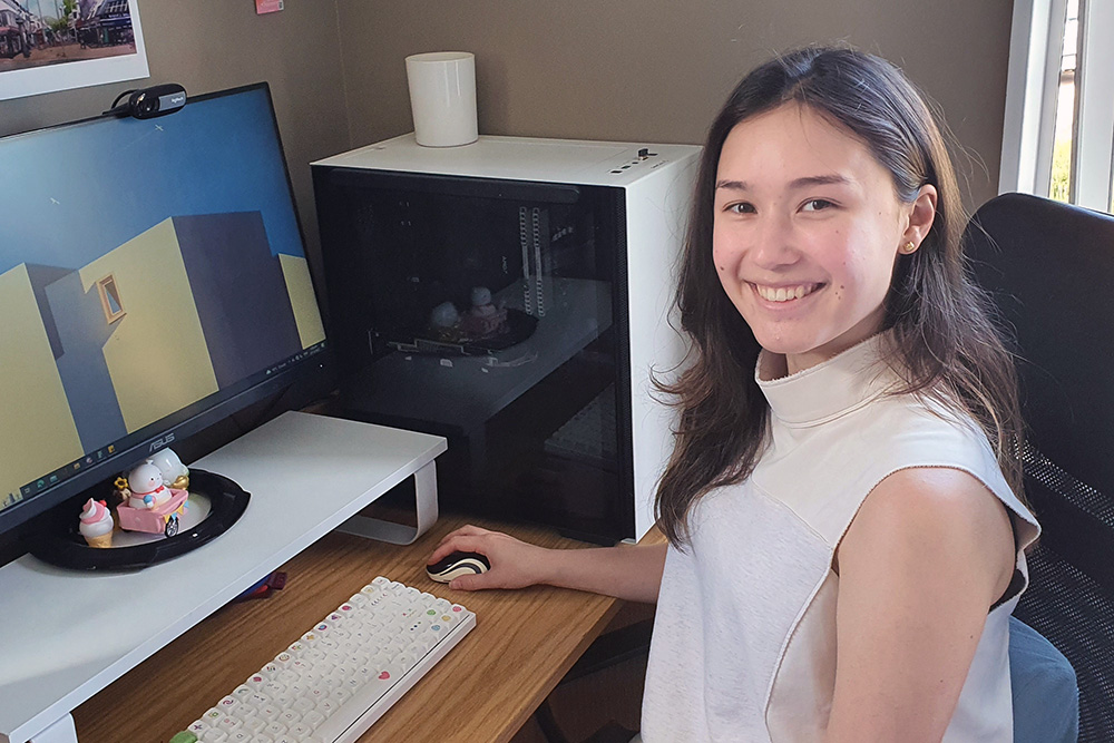 Lydia sitting at a desk in front of a computer